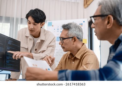 Group of asian senior in a collaborative software development analyzing  flowcharts  during a bootcamp training