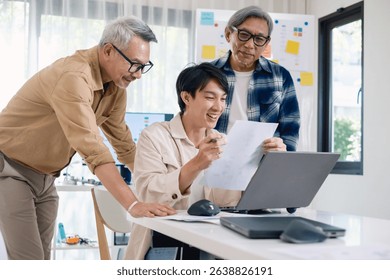 Group of asian senior in a collaborative software development analyzing flowcharts during a bootcamp training