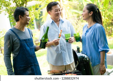 Group Of Asian Senior Early Retirement Party In Green Park Outdoor BBQ Food And Soft Drink