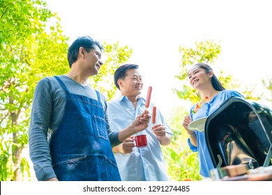 Group Of Asian Senior Early Retirement Party In Green Park Outdoor BBQ Food And Drink