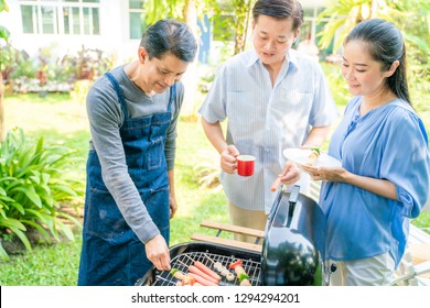 Group Of Asian Senior Early Retirement Party In Green Park Outdoor BBQ Food And Drink