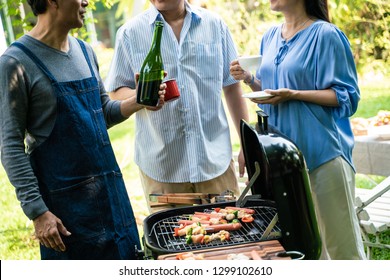 Group Of Asian Senior Early Retirement Party In Green Park Outdoor BBQ Food And Drink