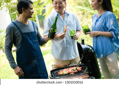 Group Of Asian Senior Early Retirement Party In Green Park Outdoor BBQ Food And Drink