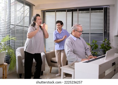 Group Of Asian Senior People Are Enjoy Music , Playing Piano , Dancing Together At Elderly Health Care Center, Elderly Group Therapy Concept