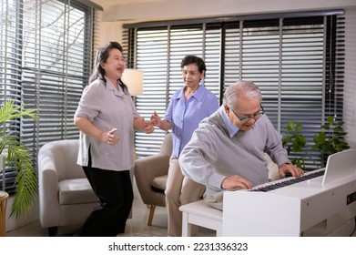 Group of Asian senior people are enjoy music , playing piano , dancing together at elderly health care center, elderly group therapy concept - Shutterstock ID 2231336323