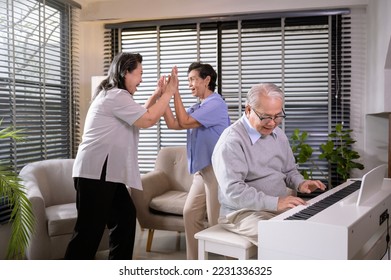Group of Asian senior people are enjoy music , playing piano , dancing together at elderly health care center, elderly group therapy concept - Shutterstock ID 2231336325