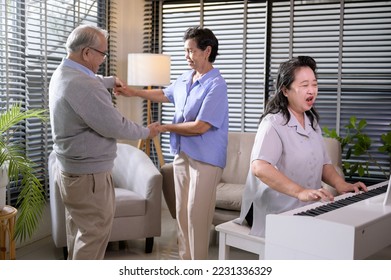 Group of Asian senior people are enjoy music , playing piano , dancing together at elderly health care center, elderly group therapy concept - Shutterstock ID 2231336329