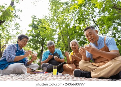 A group of Asian senior people enjoy painting cactus pots and recreational activity or therapy outdoors together  at an elderly healthcare center, Lifestyle concepts about seniority - Powered by Shutterstock