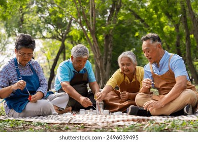 A group of Asian senior people enjoy painting cactus pots and recreational activity or therapy outdoors together  at an elderly healthcare center, Lifestyle concepts about seniority - Powered by Shutterstock