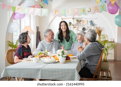 Group of Asian senior people having birthday party at home, celebrating birthday at retirement home with friends - Powered by Shutterstock