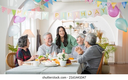 Group of Asian senior people having birthday party at home, celebrating birthday at retirement home with friends - Powered by Shutterstock