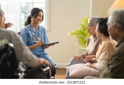 Group Of Asian Senior People Listening To Young Nurse. Psychological Support Group For Elderly And Lonely People In A Community Centre. Group Therapy In Session Sitting In A Circle In A Nursing Home.