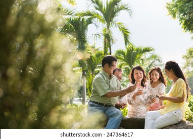 Group Of Asian Senior People Playing Cards Outdoors