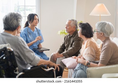 Group Of Asian Senior People Sit In A Circle In A Nursing Home And Listen To Nurse During A Group Elderly Therapy Session.