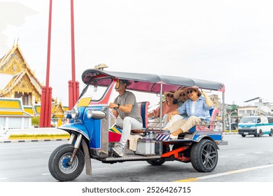 Group of Asian senior woman tourist enjoy outdoor lifestyle travel Bangkok city, Thailand on summer holiday vacation. Elderly women friends travel in the city by three wheeled vehicles Tuk Tuk taxi. - Powered by Shutterstock