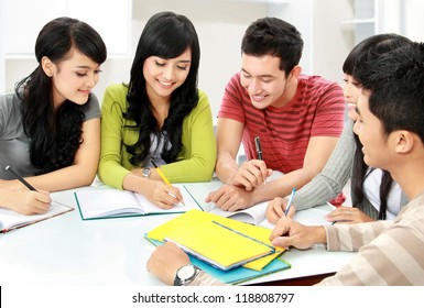 Group Of Asian Students Studying Together At Home