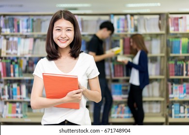 Group Of Asian Students Studying Together In Library At University. University Students. Education, Student, People Concept
