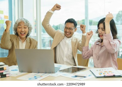 Group Of Asian Team Business People Hand Raise Up With Happiness In Meeting Room Office.Success Business And Partnership Concept.