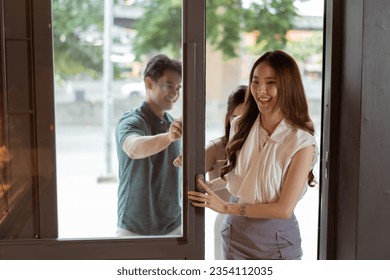 Group of Asian teenagers entering a bakery shop together. Man and women visiting a cafe with smile - Shutterstock ID 2354112035