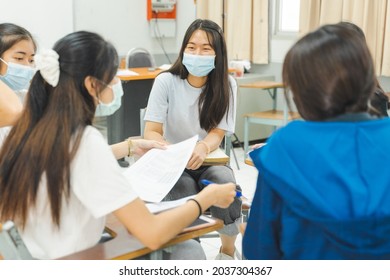 Group Asian University Students Wear Protective Face Mask Discuss Project In The Classroom