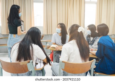 Group Asian University Students Wear Protective Face Mask Discuss Project In The Classroom