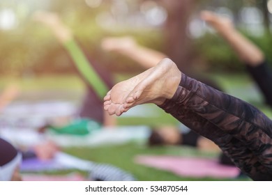 Group of asian woman doing yoga or exercise in the park - Shutterstock ID 534870544