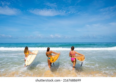 Group Of Asian Woman Surfer In Swimwear Holding Surfboard Walking Together On Tropical Beach In Sunny Day. Happy Female Friends Enjoy Outdoor Activity Lifestyle Water Sport Surfing On Summer Vacation