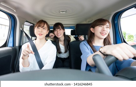 Group Of Asian Women Riding A Car.