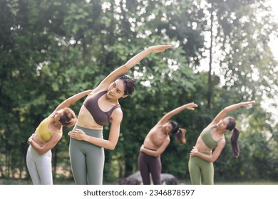 Group of Asian yoga class stretching outdoor. Sporty woman with active wear doing yoga and practicing meditation  in nature. healthy lifestyle concept. - Powered by Shutterstock