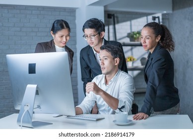Group of Asian young business people have discussion meeting in office. Attractive businessman and woman have brainstorming and working together as teamwork on overtime. Corporate of modern colleague. - Shutterstock ID 2186914179