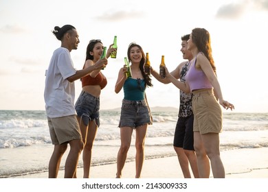 Group of Asian young man and woman having party on the beach together. Attractive friends singing and dancing while walking and running at seaside enjoy holiday vacation trip in tropical sea island. - Powered by Shutterstock