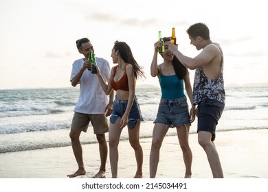 Group Of Asian Young Man And Woman Having Party On The Beach Together. Attractive Friends Singing And Dancing While Walking And Running At Seaside Enjoy Holiday Vacation Trip In Tropical Sea Island.