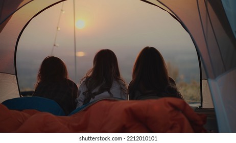 Group Asian young women enjoy the view of the sunset from a tent on the mountain, Camping trip. Video Still - Powered by Shutterstock