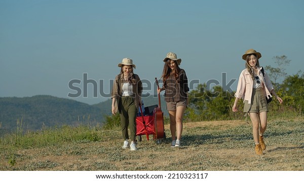 Group of\
Asian young women walking to the tent with camping gear for a\
mountain outdoor camping trip in nature during sunset, Females\
Lifestyle Vacations Relaxation. Video\
Still