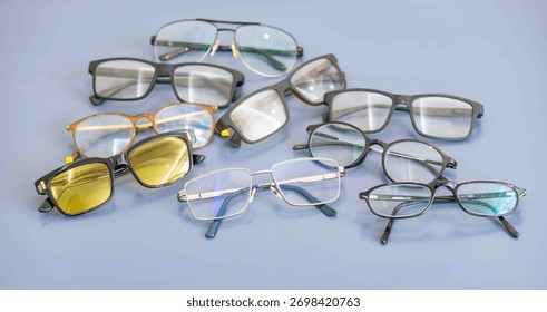 Group of assorted glasses and eyeglass frames, prescription glasses, sunglasses.