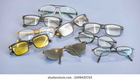Group of assorted glasses and eyeglass frames, prescription glasses, sunglasses.