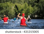 group of athletes canoeists boating on  lake in a kayak. water spray from oars