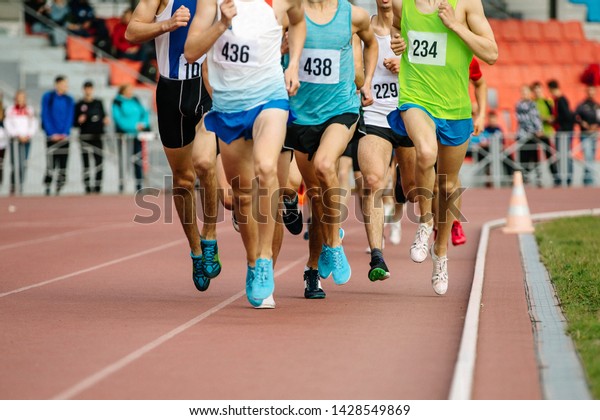 group of athletes runners middle distance\
running of competition in\
athletics