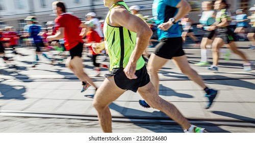 group athletes runners running marathon motion blur 