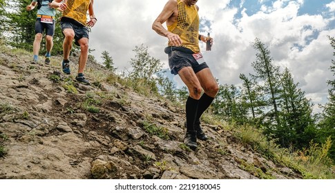 group athletes running mountain trail race - Shutterstock ID 2219180045