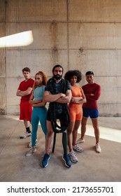 A Group Of Athletes Are Standing In A Power Pose Outdoors