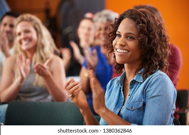 Group Attending Neighborhood Meeting Applauding Speaker In Community Center