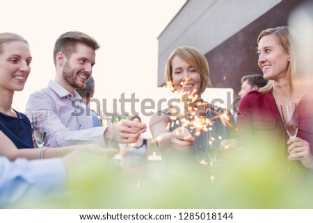 Similar – Woman holding lemonade glass and friends cooking in barbecue