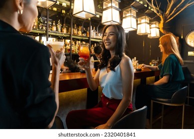 Group of Attractive woman enjoy and fun hangout nightlife meeting and drinking fancy cocktail together at luxury bar. Happy female friends celebrating holiday event party at nightclub in the city - Shutterstock ID 2320401841