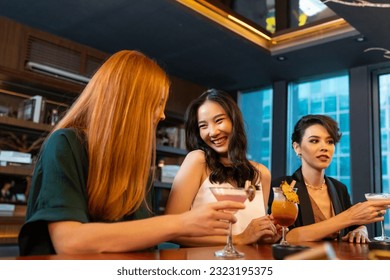 Group of Attractive woman enjoy and fun hangout nightlife meeting and drinking fancy cocktail together at luxury bar. Happy female friends celebrating holiday event party at nightclub in the city - Shutterstock ID 2323195375