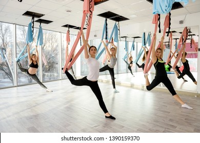 Group Of Attractive Women Doing Fly Yoga In Gym