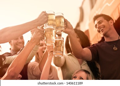 Group of Attractive young People toasting with a delicious Pale Ale  Beer