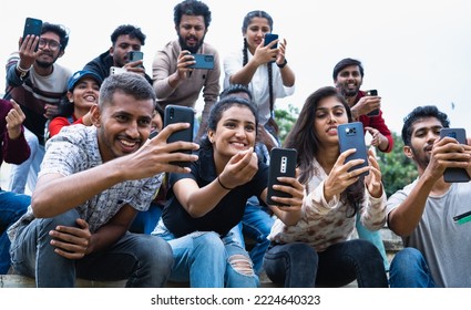 Group of audience or crowd taking photos of a player at stadium on mobile phone - concept of technology, social media sharing and fan following - Powered by Shutterstock