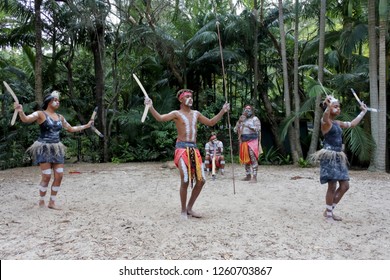 Group Of Australian Aboriginal People Dancing To Didgeridoo Musical Instrument Sound Rhythm In Queensland, Australia. Real People. Copy Space.