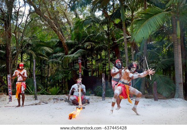 Group of Australian\
Aboriginal people dancing and play music of  Indigenous Australian\
dance during a culture show in the tropical far north of\
Queensland, Australia. 